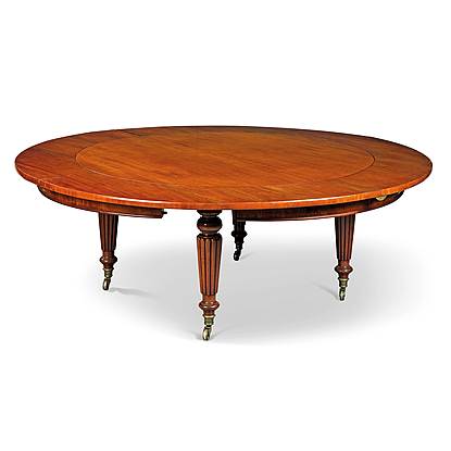 An Antique Extending Circular Dining Table with additional leaves to make it larger