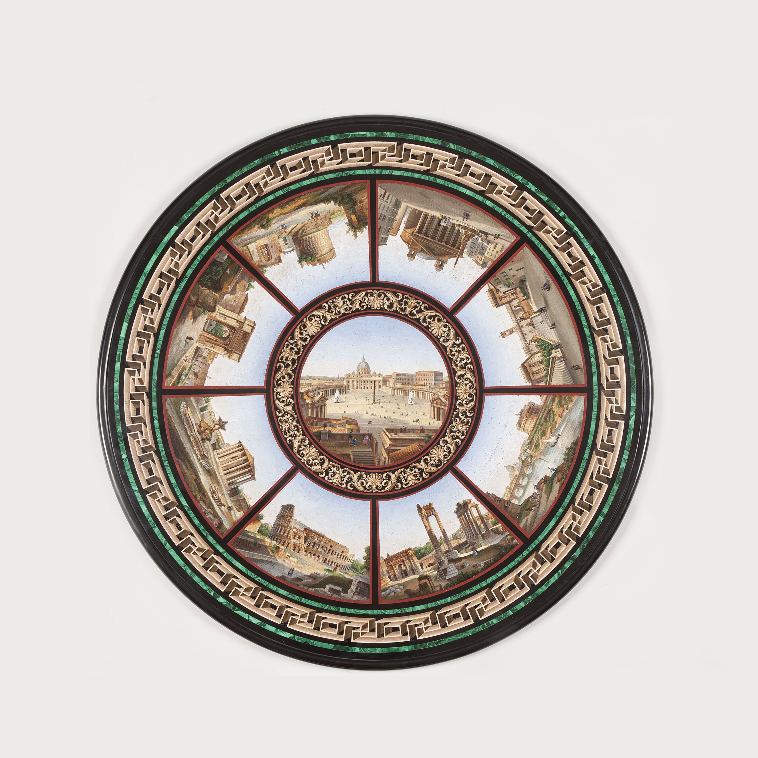 Circular micromosaic tabletop featuring a central view of Saint Peter's Square surrounded by eight radiating vignettes of Roman landmarks. A Greek key border and malachite rim frame the intricate scenes.
