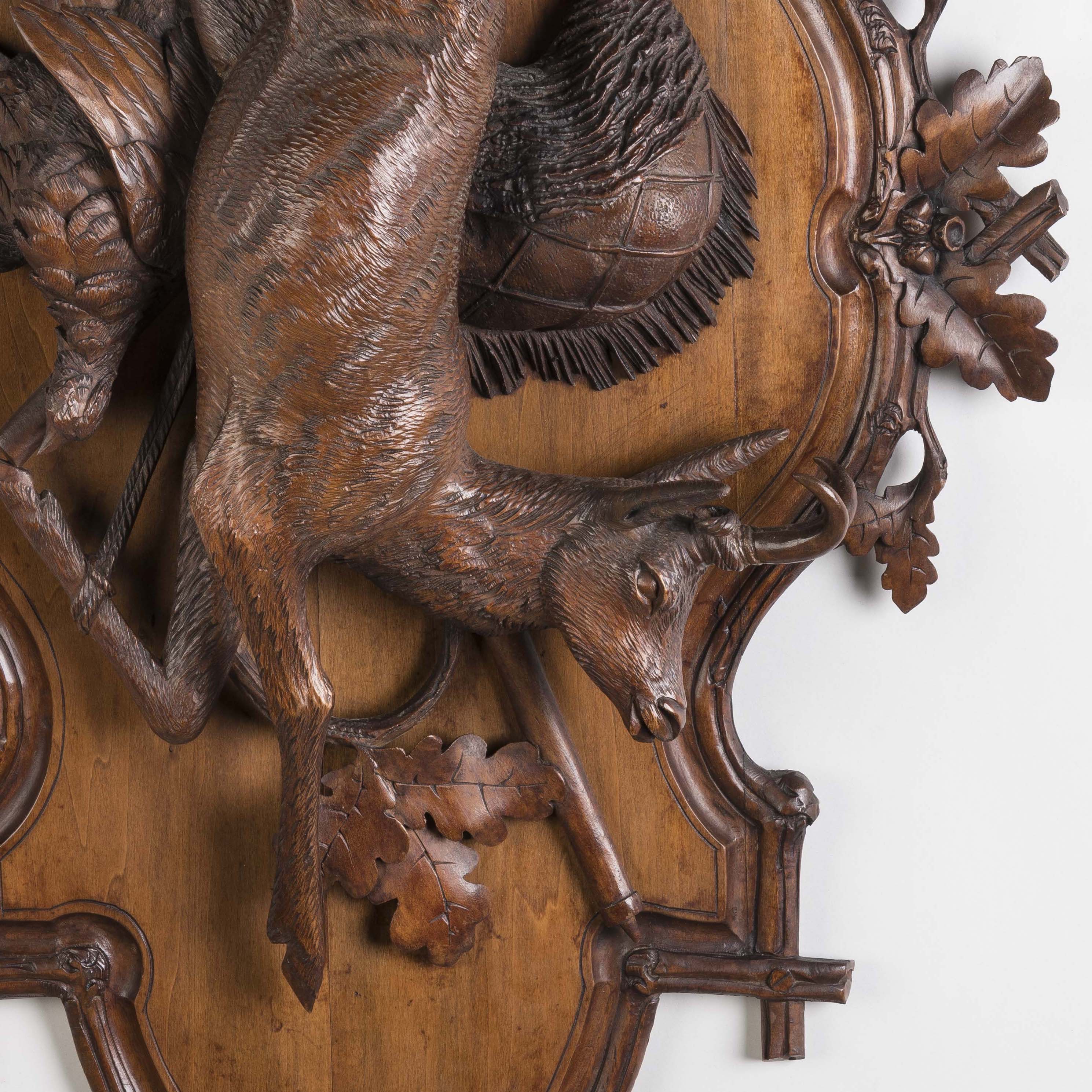 A Pair of Carved Black Forest Game Plaques