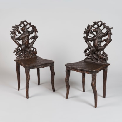A Pair of Carved Black Forest Chairs