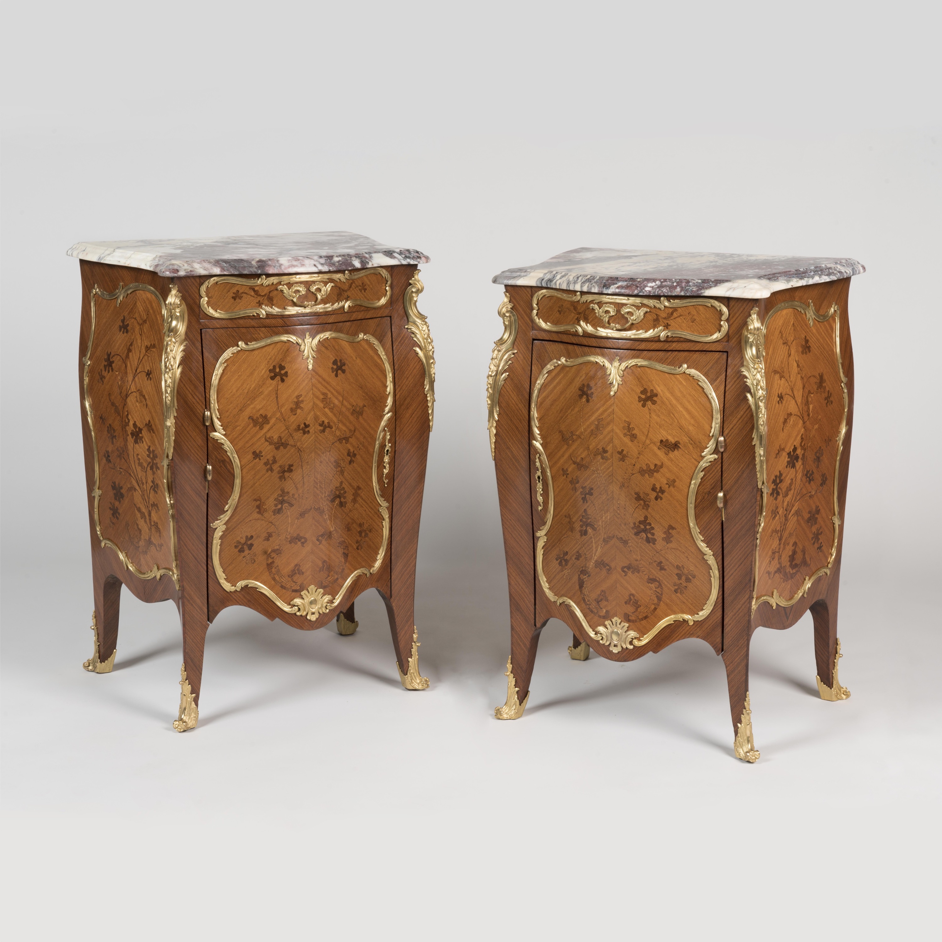 A Pair of Louis XV Style Bombé Bedside Cabinets