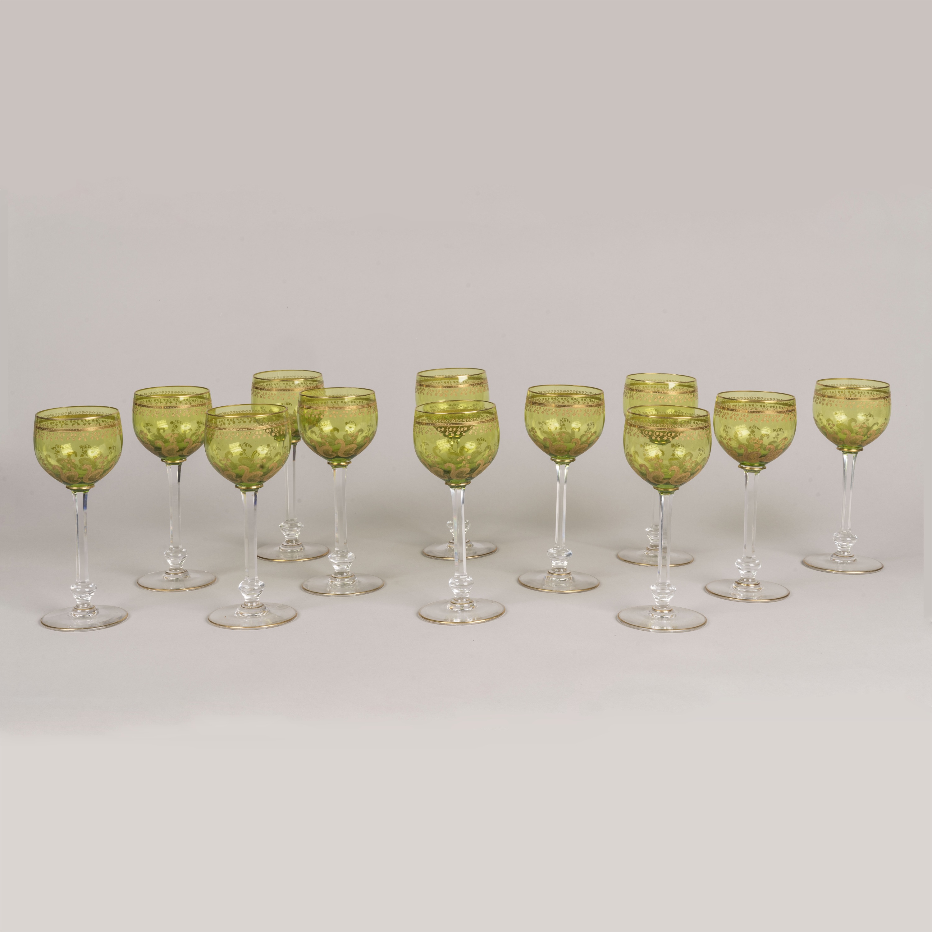 A Set of Twelve Green & Gilt Overlay Crystal Glasses