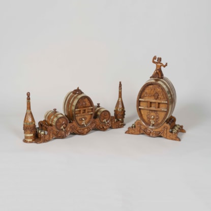 A Carved Oak Barrel Drinks Set