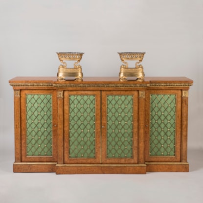 A Regency Period Parcel Gilt and Amboyna  Breakfront Side Cabinet