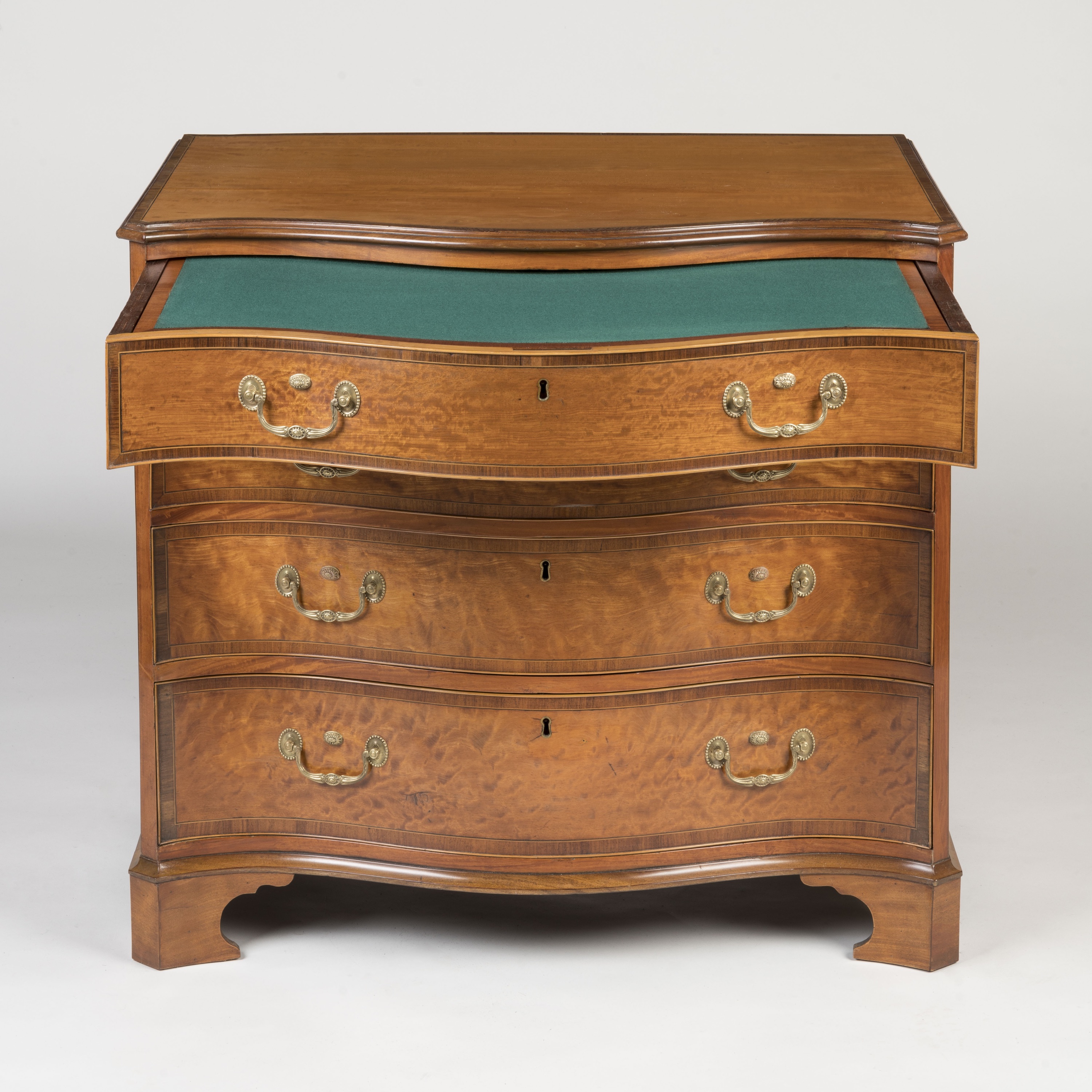 A Fine Satinwood Serpentine Chest of Drawers Of the George III Period