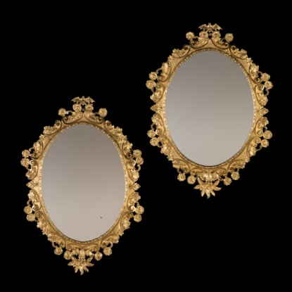 A Pair of English Ormolu Framed Oval Mirrors