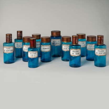 A Rare Set of 12 Turquoise Glass Apothecary Jars & Bottles